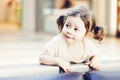 Closeup portrait of cute adorable smiling white Caucasian toddler girl child with dark brown eyes and curly pig-tails Royalty Free Stock Photo