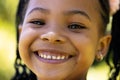 Closeup portrait of cute african american smiling girl with dreadlocks looking at camera Royalty Free Stock Photo