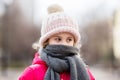 Closeup portrait of cute baby girl wearing knitted hat and winter jacket outdoors Royalty Free Stock Photo