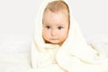 Closeup portrait of cute baby under towel on the bed Royalty Free Stock Photo