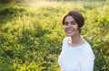 Portrait of cute brunette teen girl walking at meadow field Royalty Free Stock Photo