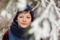 Closeup portrait of cute child boy in winter forest Royalty Free Stock Photo