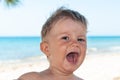 Closeup portrait cute happy baby boy in front of sea Royalty Free Stock Photo