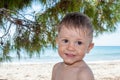 Closeup portrait cute happy baby boy in front of sea Royalty Free Stock Photo