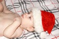 Closeup portrait of a cute little baby boy wearing red Santa Claus traditional Christmas costume.Christmas of infant in red cap. N Royalty Free Stock Photo