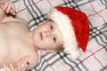 Closeup portrait of a cute little baby boy wearing red Santa Claus traditional Christmas costume.Christmas of infant in red cap. N Royalty Free Stock Photo