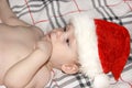 Closeup portrait of a cute little baby boy wearing red Santa Claus traditional Christmas costume.Christmas of infant in red cap. N Royalty Free Stock Photo