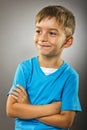 Closeup portrait of a cute little boy with arms folded