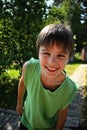 Closeup portrait cute little boy smiling in a park Royalty Free Stock Photo