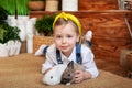 Closeup portrait of cute little girl and white and brown rabbits. Child playing with rabbits. Easter celebration. Concept child an Royalty Free Stock Photo