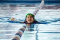 Closeup portrait of cute little peruvian girl swimming in the pool, happy child having fun in water. Royalty Free Stock Photo