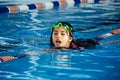 Closeup portrait of cute little peruvian girl swimming in the pool, happy child having fun in water. Royalty Free Stock Photo