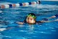 Closeup portrait of cute little peruvian girl swimming in the pool, happy child having fun in water. Royalty Free Stock Photo