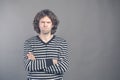 Closeup portrait displeased, angry grumpy man in striped sweater bad attitude, arms crossed, folded, looking at you, isolated gray Royalty Free Stock Photo