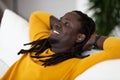 Closeup Portrait Of Dreamy Black Man Leaning Back On Couch And Smiling Royalty Free Stock Photo