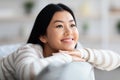 Closeup Portrait Of Dreamy Happy Young Asian Woman Relaxing At Home