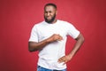 Closeup portrait of dumb clueless young african man, arms out asking why what`s the problem who cares so what, I don`t know. Royalty Free Stock Photo