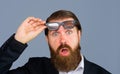 Closeup portrait of excited astonished shocked man takes off glasses. Amazed bearded man in suit taking-off his Royalty Free Stock Photo