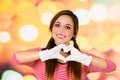 Closeup portrait of female clown mime making a heart with hands