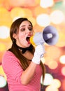 Closeup portrait of female clown mime screaming with a megaphone