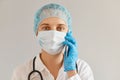 Closeup portrait of female doctor or nurse wearing medical uniform, posing with stethoscope, holding smart phone, having Royalty Free Stock Photo