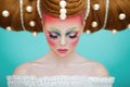 Closeup portrait of a female model with a creative colorful makeup and hairstyle. The concept of hairdressing art