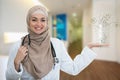 Closeup portrait of friendly, smiling confident Muslim female doctor holding molecules Royalty Free Stock Photo