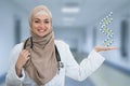 Closeup portrait of friendly, smiling confident Muslim female doctor holding molecules Royalty Free Stock Photo