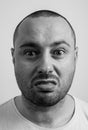 Closeup portrait of funny angry young bully man sticking his tongue out at you camera gesture, isolated on white background. You Royalty Free Stock Photo