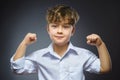 Closeup Portrait of Funny Little child. Sport Handsome Boy. Strong serious kid showing his hand biceps muscles Royalty Free Stock Photo