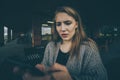 Closeup portrait funny shocked anxious scared young girl looking at phone seeing bad news photos message with disgusting Royalty Free Stock Photo