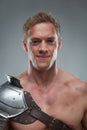 Closeup portrait of Gladiator in armour over grey Royalty Free Stock Photo