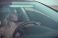 Closeup portrait of gorgeous tanned blond lady driving the