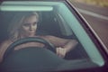 Closeup portrait of gorgeous tanned blond lady driving the