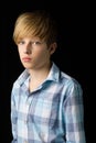 Closeup portrait of handsome blond boy. Studio photo on a black background. Royalty Free Stock Photo