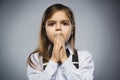 Closeup Portrait of handsome girl with astonished expression while standing against grey background Royalty Free Stock Photo