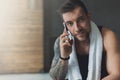 Closeup portrait of handsome man call mobile phone in gym Royalty Free Stock Photo
