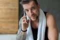 Closeup portrait of handsome man call mobile phone in gym Royalty Free Stock Photo