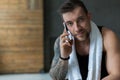 Closeup portrait of handsome man call mobile phone in gym Royalty Free Stock Photo