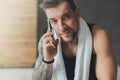 Closeup portrait of handsome man call mobile phone in gym Royalty Free Stock Photo