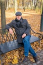 Closeup portrait of handsome middle-aged full-length brunette man. A mature handsome man of 45-50 years walks in autumn park in Royalty Free Stock Photo