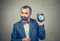 Man holding alarm clock in his hand Royalty Free Stock Photo