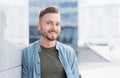 Closeup portrait of handsome smiling young man. Cheerful businessman in a city Royalty Free Stock Photo