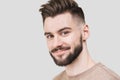 Closeup portrait of handsome smiling young man. Cheerful men isolated on gray background studio shot