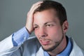 Closeup portrait of handsome young confused doctor