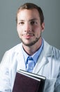 Closeup portrait of handsome young doctor holding Royalty Free Stock Photo