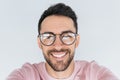 Closeup portrait of handsome young happy smiling bearded male model look at the camera, wears round trendy glasses with toothy Royalty Free Stock Photo