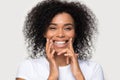 Closeup portrait happy african woman cleaning teeth with dental floss Royalty Free Stock Photo