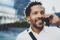 Closeup portrait of happy American African man using smartphone to call his friends at sunny city.Concept of happy young Royalty Free Stock Photo