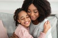 Closeup portrait of happy black mother and daughter hugging Royalty Free Stock Photo